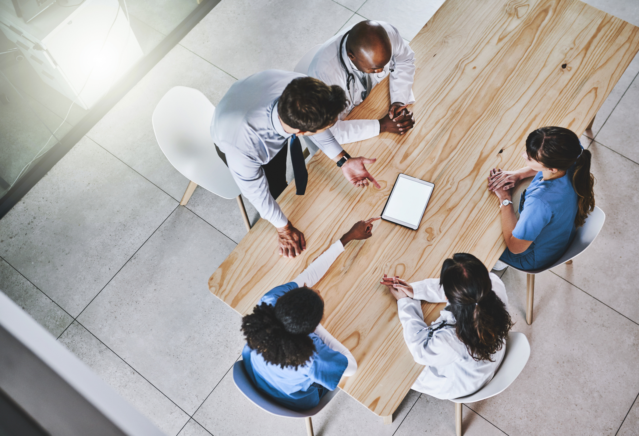 multidisciplinary healthcare team discussing subject at office table